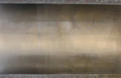 Inside a cylinder liner showing negligible bore polish with cross hatching intact.