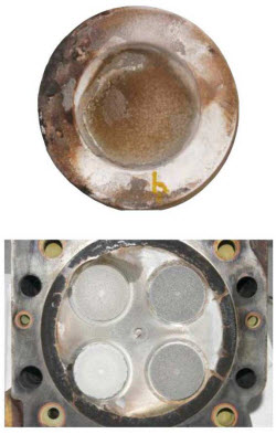 Top of the piston/cylinder head fireface shown having minimal excess ash deposits.